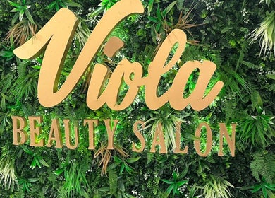 Viola Beauty Salon sign amidst lush greenery at Al Mubarraz, Eastern Province, SA.