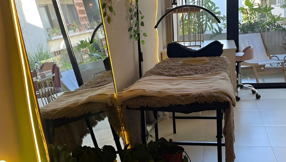 Cama de masaje en Bel Studio Castelar, Morón, Provincia De Buenos Aires, AR, con vistas a un jardín luminoso.