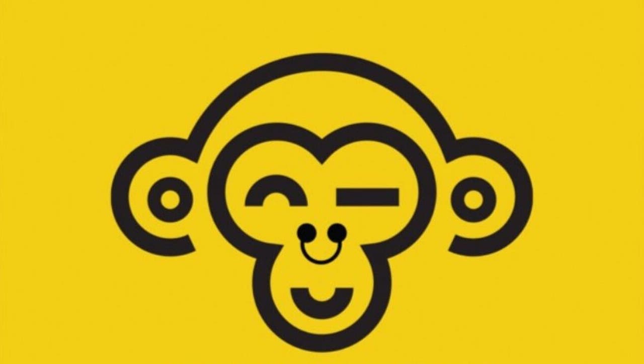 Cheerful monkey logo for Monkey Piercing in Salmiya, Hawalli Governorate, KW, on vibrant yellow background.