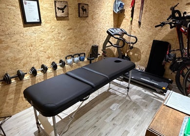 Therapy room at Everything Rehab, Northampton, England, GB featuring a massage table, weights, and treadmill.