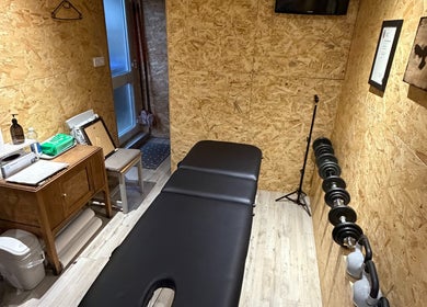 Therapy room at Everything Rehab in Northampton, England, GB with a massage table and fitness equipment.