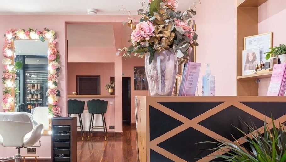 Interior of Ami Stylist in Portmore, St. Catherine Parish, JM, featuring floral decor and chic seating areas.