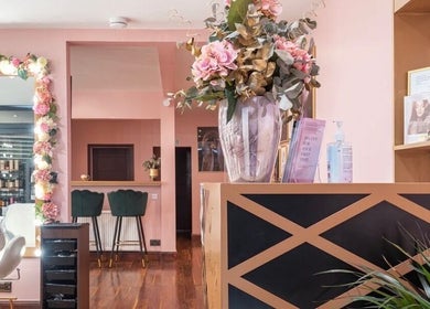Interior of Ami Stylist in Portmore, St. Catherine Parish, JM, featuring floral decor and chic seating areas.