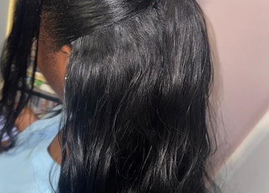 Sleek black hairstyle at Galorebeautylounge, London, England, GB. Expert styling for shiny, healthy hair.