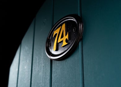 Close-up of a stylish '74' doorplate at Chatterbox, Lisburn, Northern Ireland, GB.