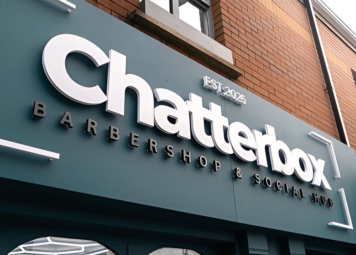 Exterior sign of Chatterbox barbershop in Lisburn, Northern Ireland, GB showcasing modern branding.