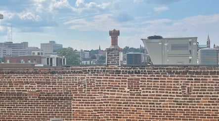 View of Macon skyline from FEW FACED SELF, showcasing rustic brick and cityscape in Macon, Georgia, US.