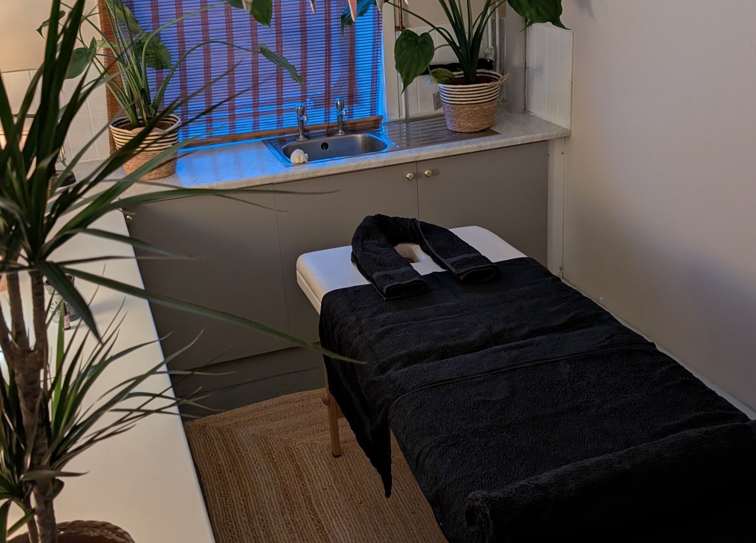 Quiet massage room at Wave Massage Studio in Portland, England, GB, with calming decor and soft lighting.