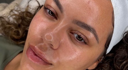 Relaxed client with glowing skin at SLT SKN CLUB, Bolton, England, GB for ultimate wellness experience.