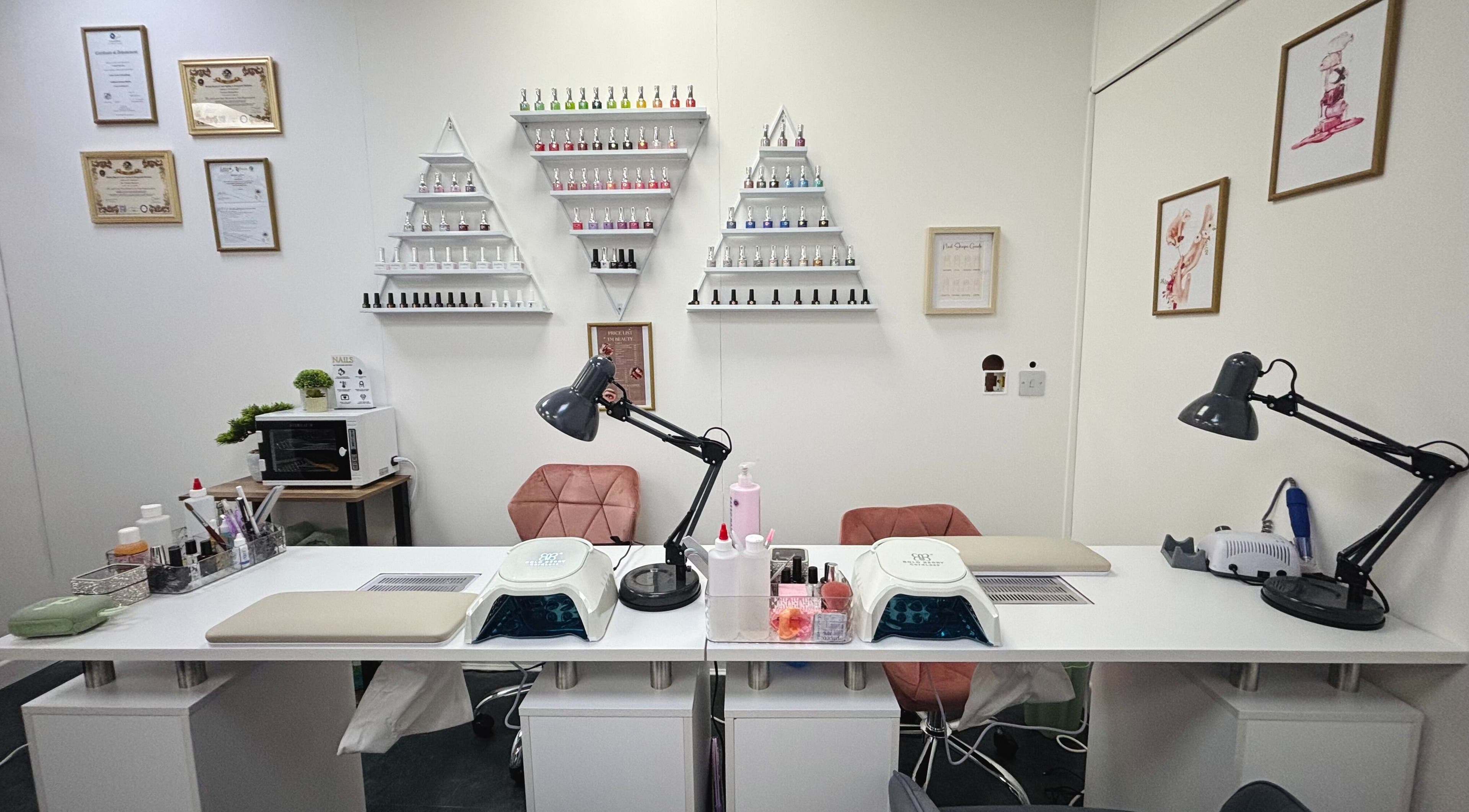 Modern nail station at T&M Beauty Salon, Glasgow, Scotland, GB with polish racks and professional equipment.