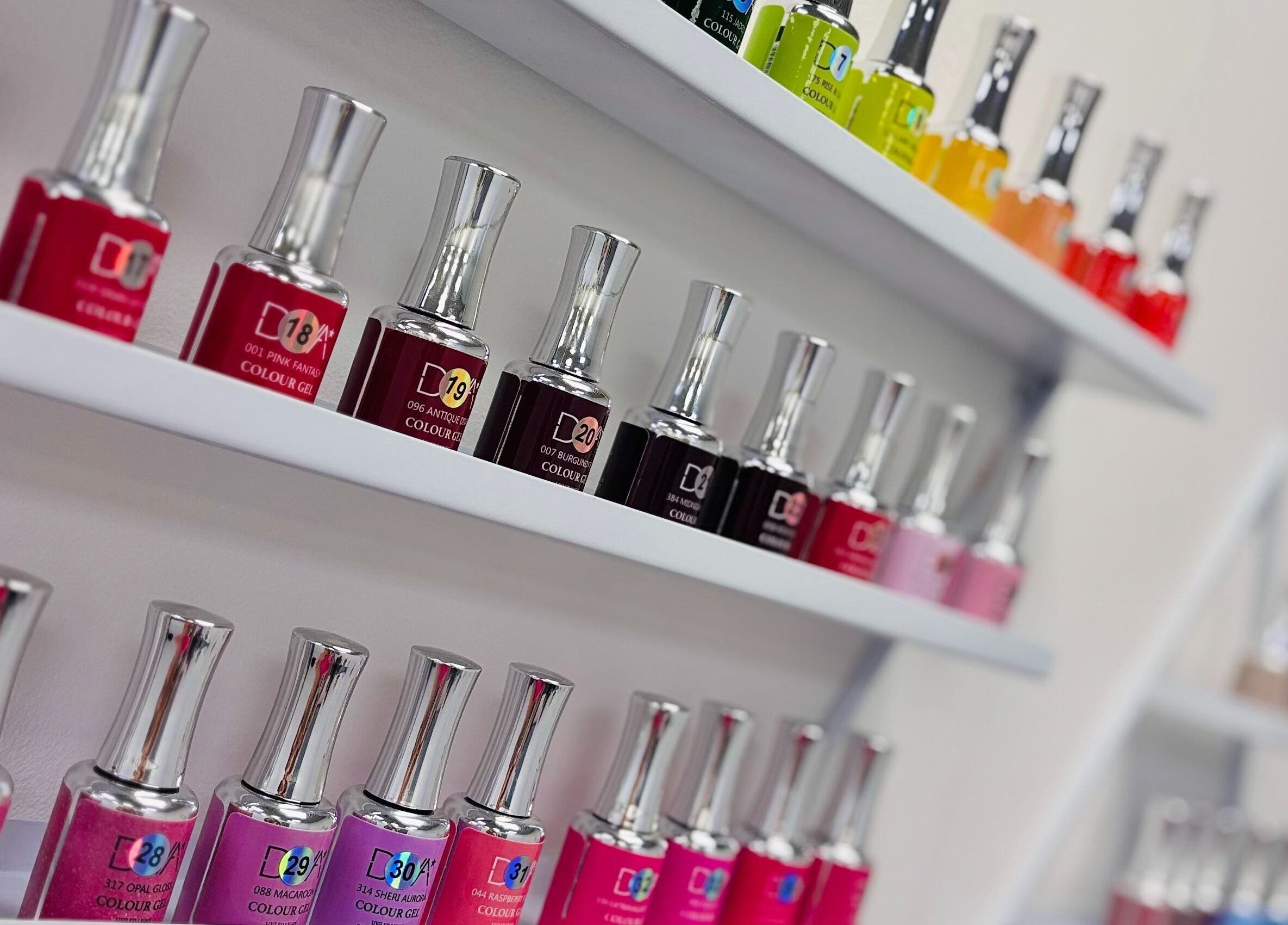 Colorful nail polish bottles lined up at T&M Beauty Salon, Glasgow, Scotland, GB.