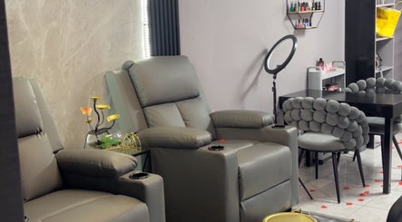 Comfortable seating at Maya’s Gorgeous Nails, Paramaribo, SR, with modern decor and nail polish display.