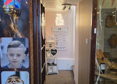 Entrance to Bare Beauty, Arundel, England with cozy decor and glowing sign.