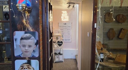 Entrance to Bare Beauty, Arundel, England with cozy decor and glowing sign.