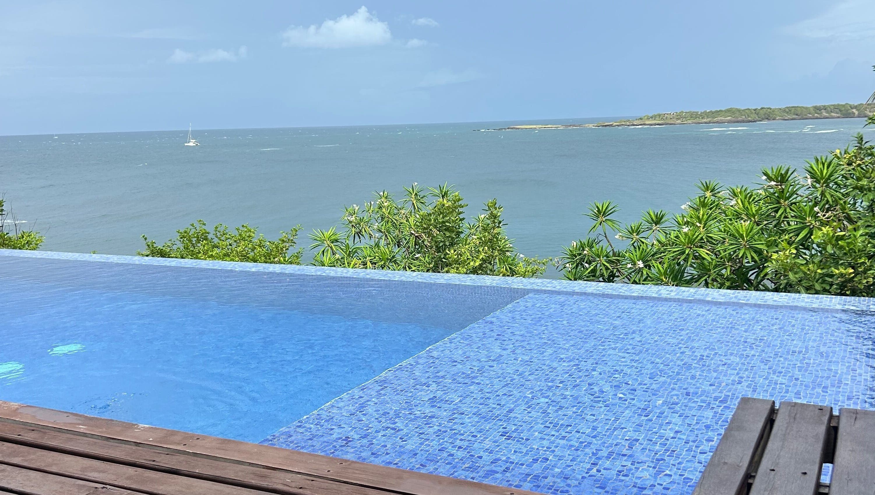 Infinity pool overlooking vibrant blue sea at JusstBraids, Oistins, Christ Church, BB.