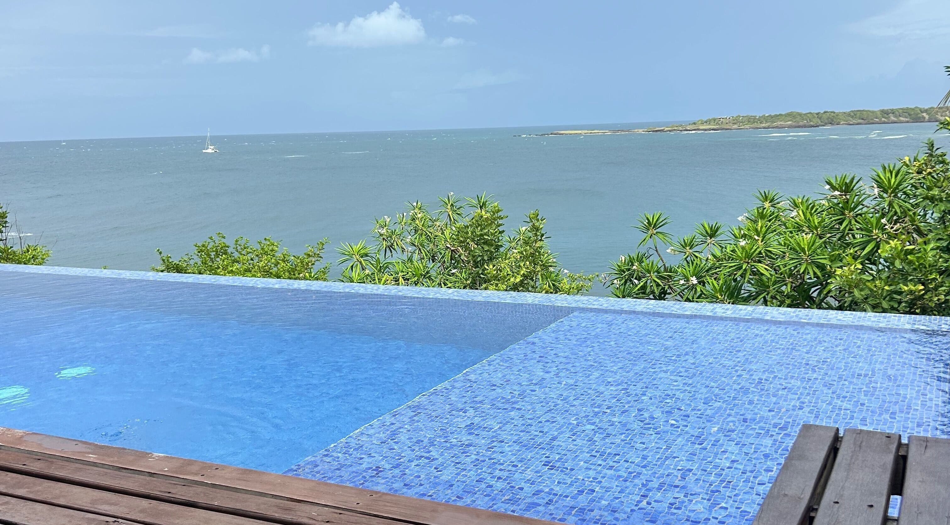 Infinity pool overlooking vibrant blue sea at JusstBraids, Oistins, Christ Church, BB.