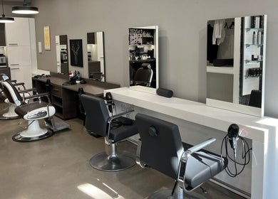 Innenansicht von Polat Der Friseur in Neuss, Nordrhein-Westfalen, DE mit stilvollen Friseurstühlen und Spiegeln.