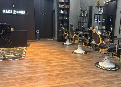 Elegant interior of Facelook barbershop in Doha, Doha Municipality, QA, featuring modern barber chairs and decor.