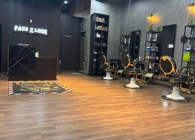 Stylish interior of Facelook barbershop in Doha, Doha Municipality, QA with modern chairs and decor.
