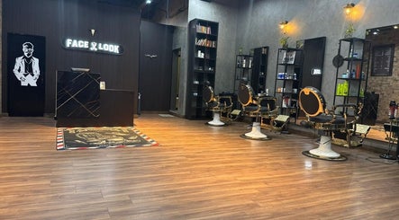 Stylish interior of Facelook barbershop in Doha, Doha Municipality, QA with modern chairs and decor.
