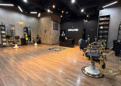 Luxurious interior of Facelook salon in Doha, Doha Municipality, QA, showcasing stylish barber chairs and sleek decor.