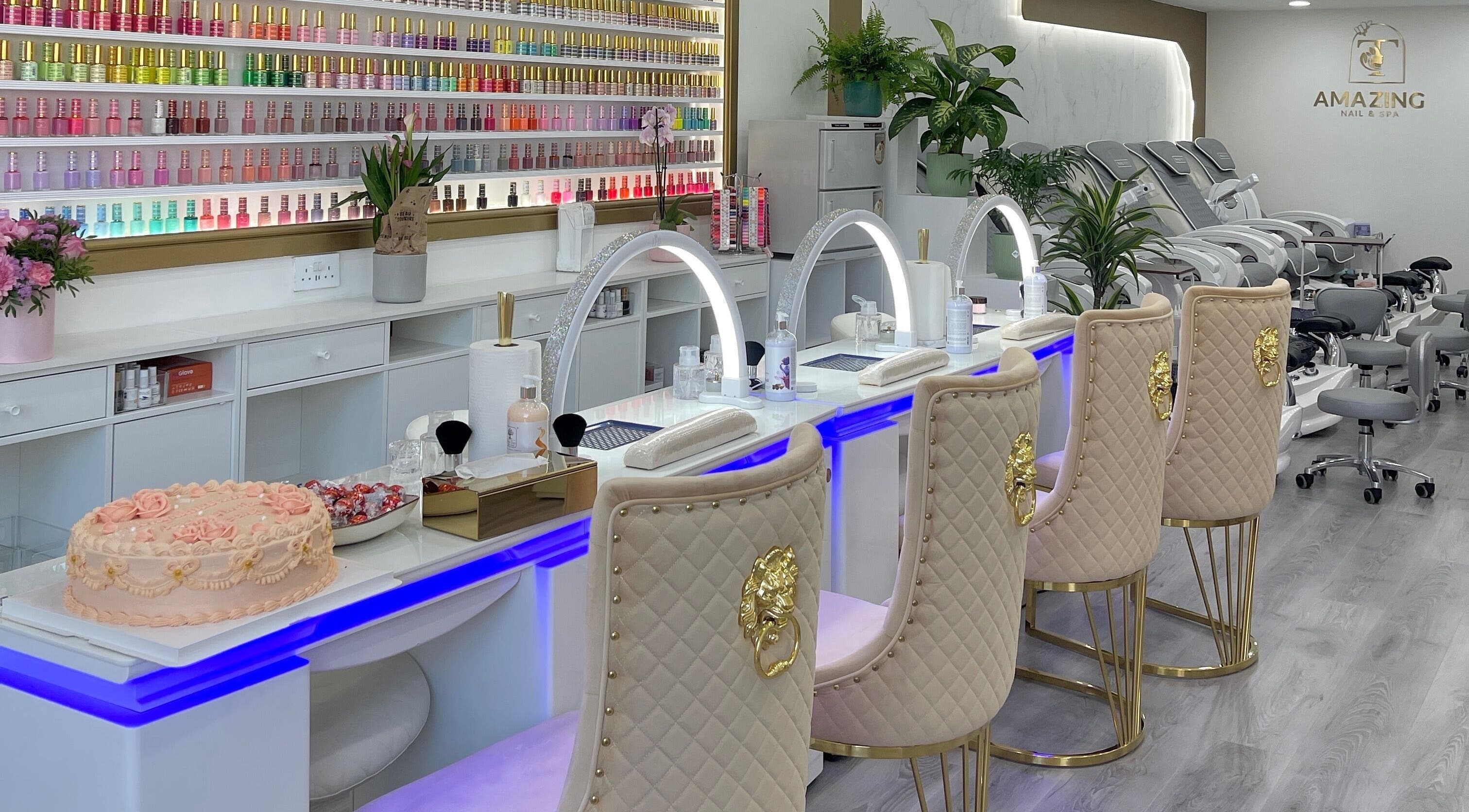 Elegant interior of Amazing Nails & Spa in Dublin, County Dublin, IE showcasing plush seating and nail polish display.