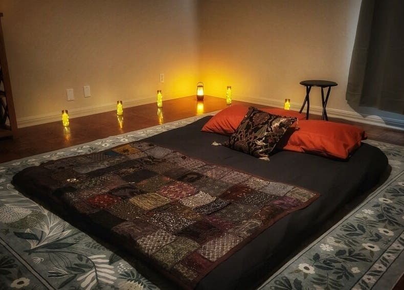Cozy massage area with dim lighting at Claudia Gomez, LMT, in Austin, Texas, US, offering relaxation and wellness.