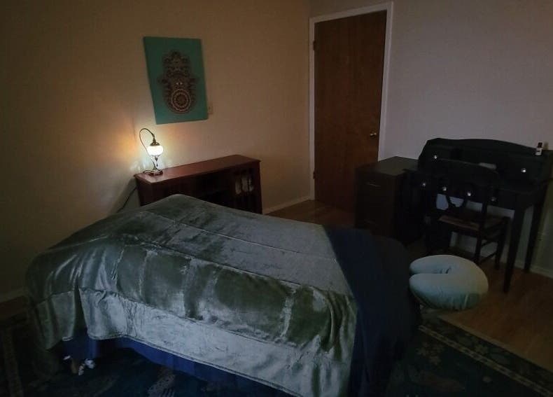 Cozy massage room at Claudia Gomez, LMT in Austin, Texas, US with soft lighting and a plush massage table.