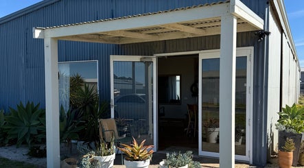 Entrance to Tide Hair Se with plants in Robe, South Australia, AU.