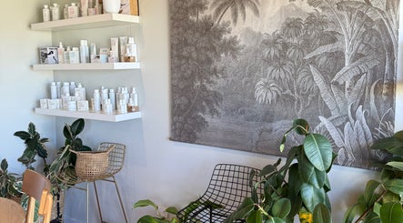 Serene interior of Tide Hair Se featuring lush plants and elegant decor, located in Robe, South Australia, AU.