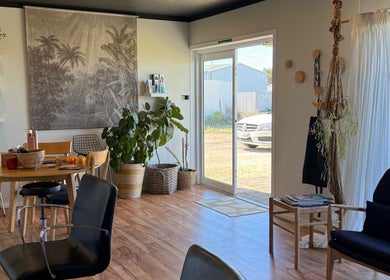 Cozy interior of Tide Hair Se in Robe, South Australia, AU, featuring natural decor and plants.