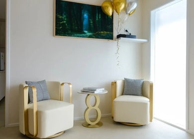 Elegant waiting area at iBeauty Cosmetic Clinic, Bundall, Queensland, AU featuring stylish chairs and decor.