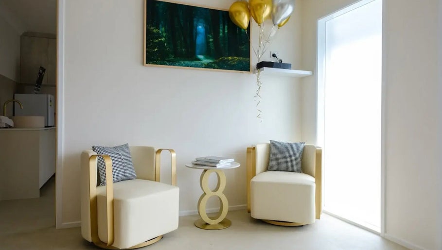 Elegant seating with gold accents at iBeauty Cosmetic Clinic, Bundall, Queensland, AU, offering a serene ambiance.