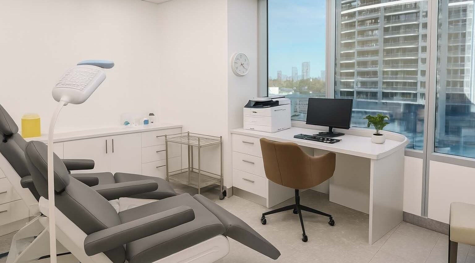 Modern treatment room at Gold Coast Hair Transplant Centre, Southport, Queensland, AU with a reclining chair and desk.