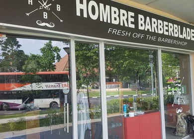 Front entrance of Hombre Barbers (Eunos), Singapore, showcasing the inviting barber shop façade.
