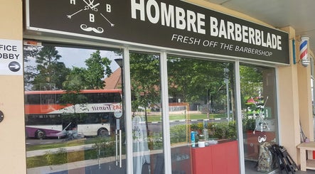 Front entrance of Hombre Barbers (Eunos), Singapore, showcasing the inviting barber shop façade.