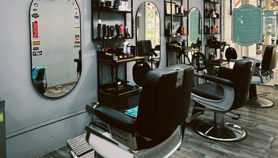 Modern barber chairs at Hombre Barbers (Tampines) in Singapore, SG showcasing a stylish interior.