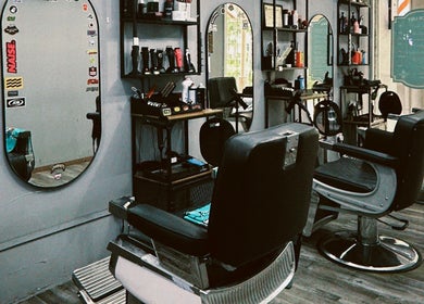 Modern barber chairs at Hombre Barbers (Tampines) in Singapore, SG showcasing a stylish interior.
