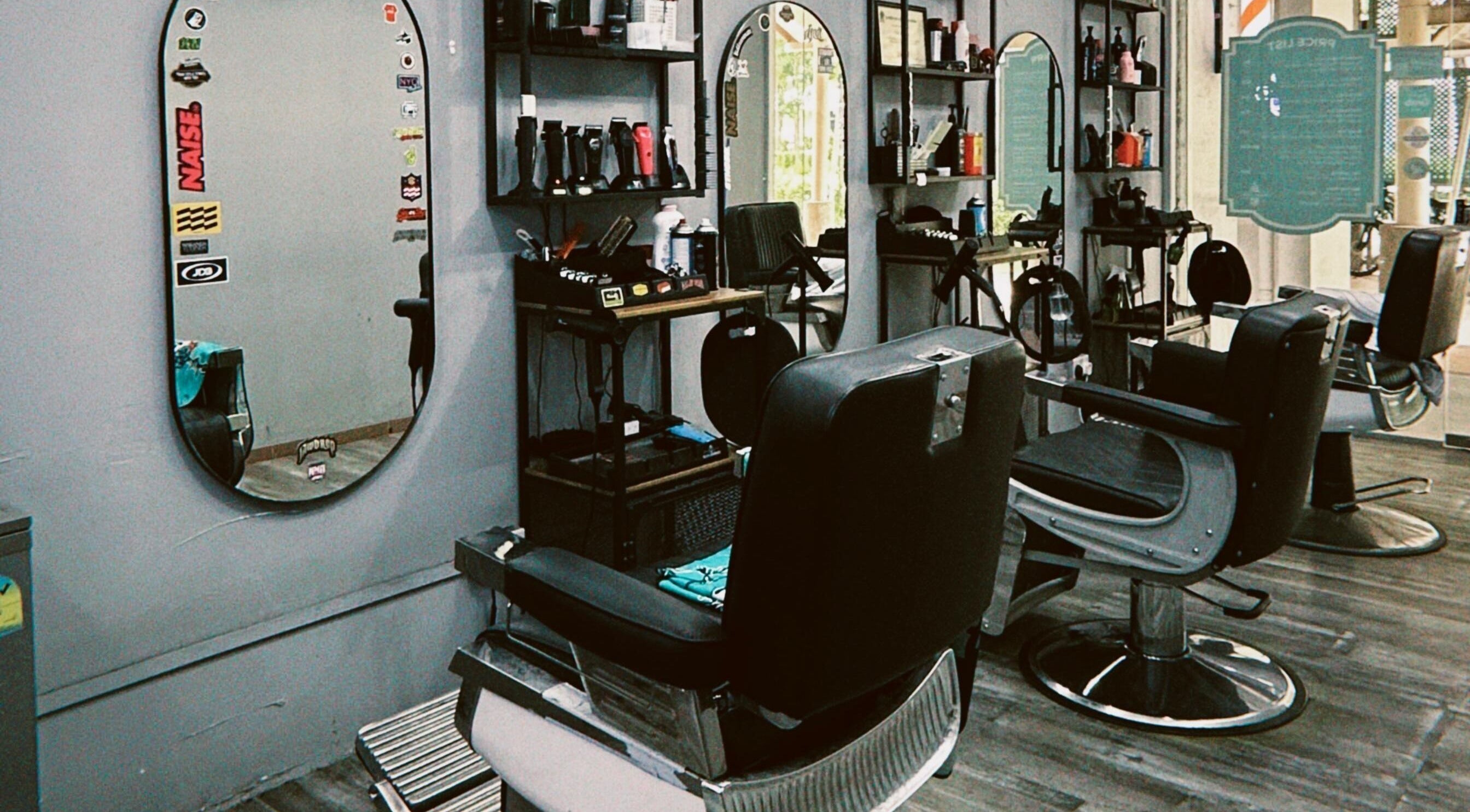 Modern barber chairs at Hombre Barbers (Tampines) in Singapore, SG showcasing a stylish interior.