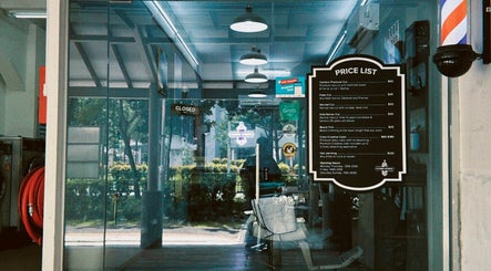 Entrance of Hombre Barbers (Tampines) with price list displayed, located in Singapore, Singapore, SG.