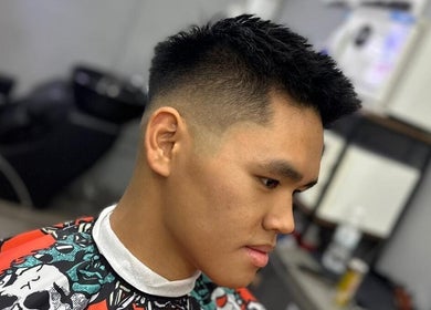 Modern haircut at Hombre Barbers (Tampines), Singapore, SG featuring a sleek fade style.