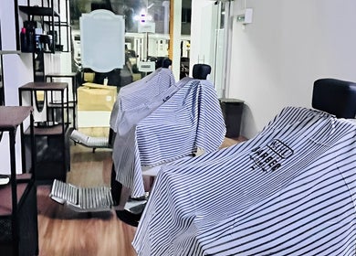 Modern interior of Hombre Barbers (Bishan), Singapore, Singapore, SG with stylish barber chairs and sleek design.