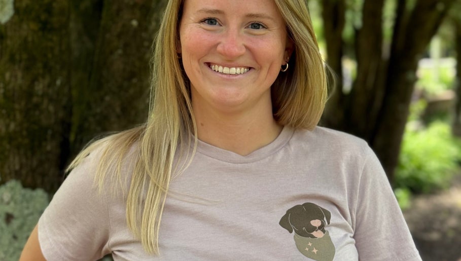 Smiling woman with blonde hair at The Grooming Studio, Ladoga, Indiana, US, wearing a dog print t-shirt.