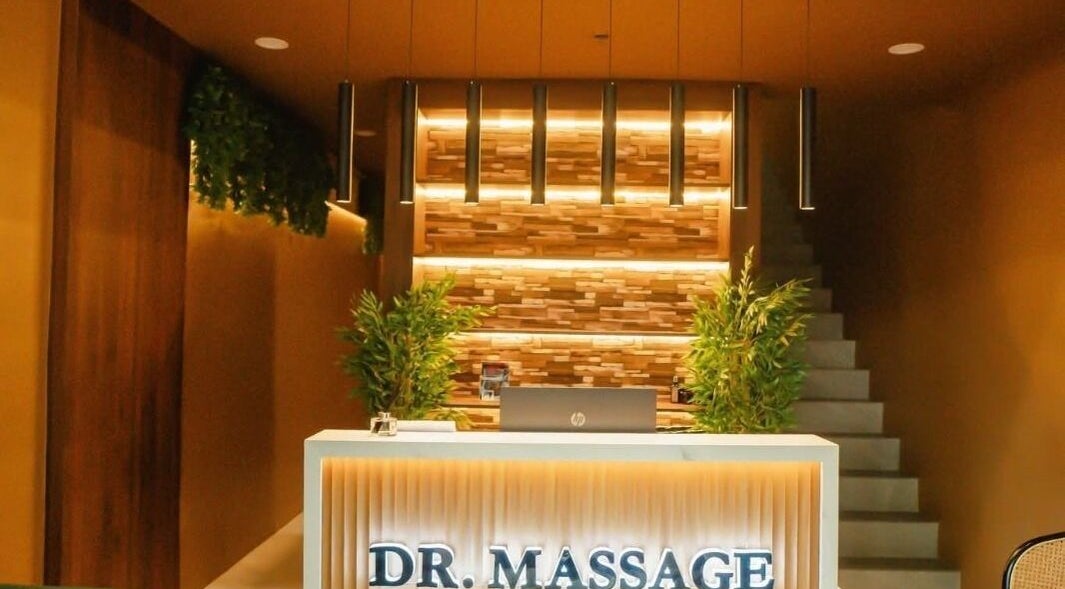 Reception area at Dr. Massage in Taguig, Metro Manila, PH showcasing warm lighting and greenery.