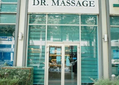Front view of Dr. Massage in Taguig, Metro Manila, PH with glass doors and lush greenery.