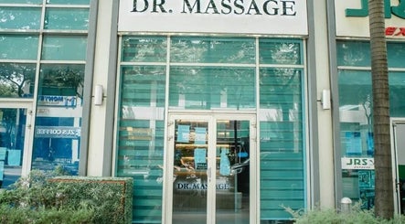 Front view of Dr. Massage in Taguig, Metro Manila, PH with glass doors and lush greenery.