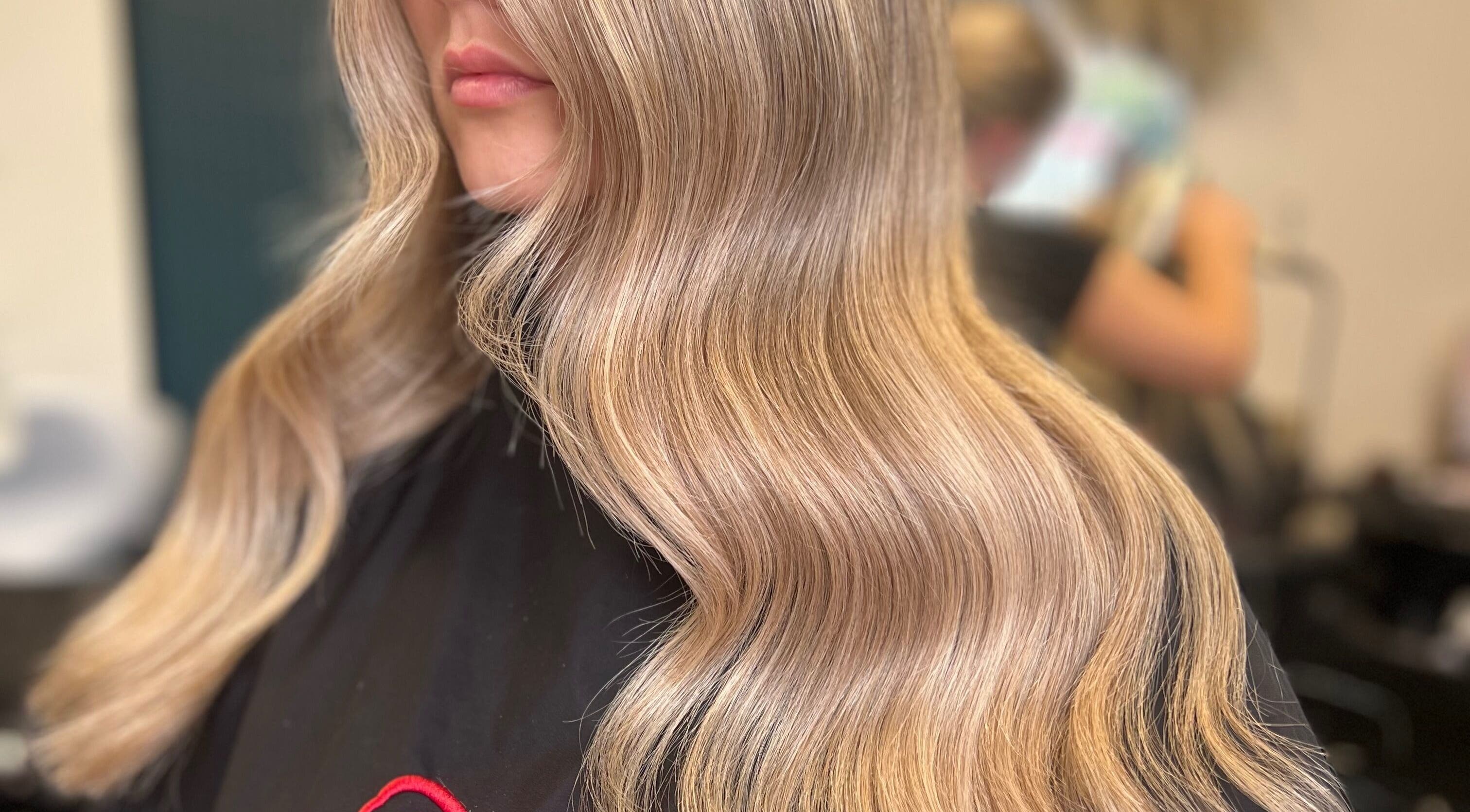 Flowing blonde waves styled at Kelly Griffiths Hair, Wrexham, Wales, GB, showcasing elegant hairstyling.