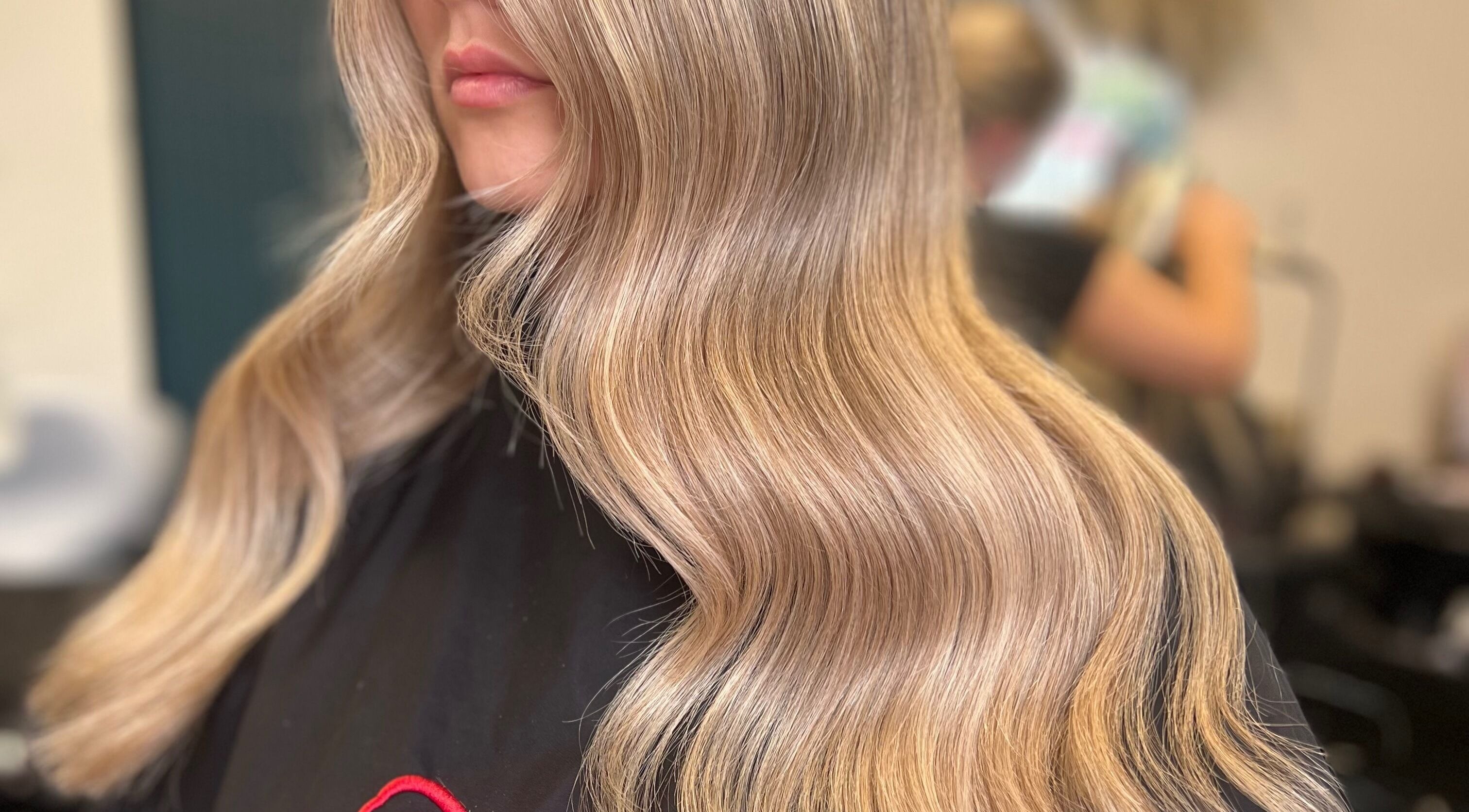 Flowing blonde waves styled at Kelly Griffiths Hair, Wrexham, Wales, GB, showcasing elegant hairstyling.