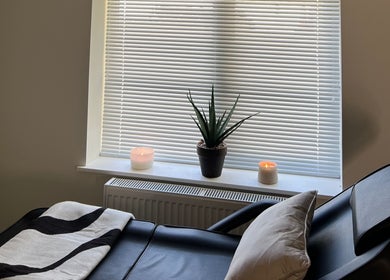 Relaxing massage chair at Babylon, Ballaugh, England, GB with candles and a plant for tranquility.