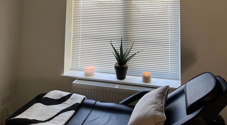 Relaxing massage chair at Babylon, Ballaugh, England, GB with candles and a plant for tranquility.